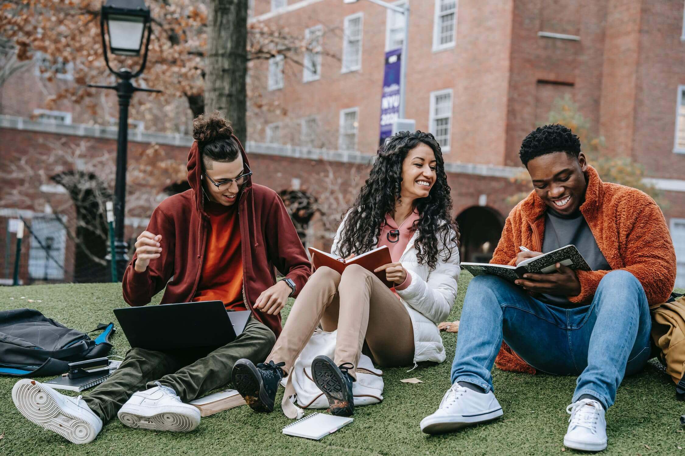 a group of people sitting on the grass