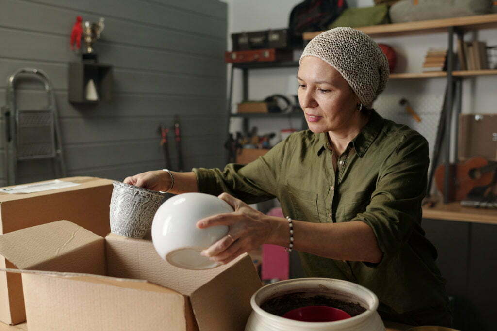 Contemporary mature female gardener preparing flowerpots for new season