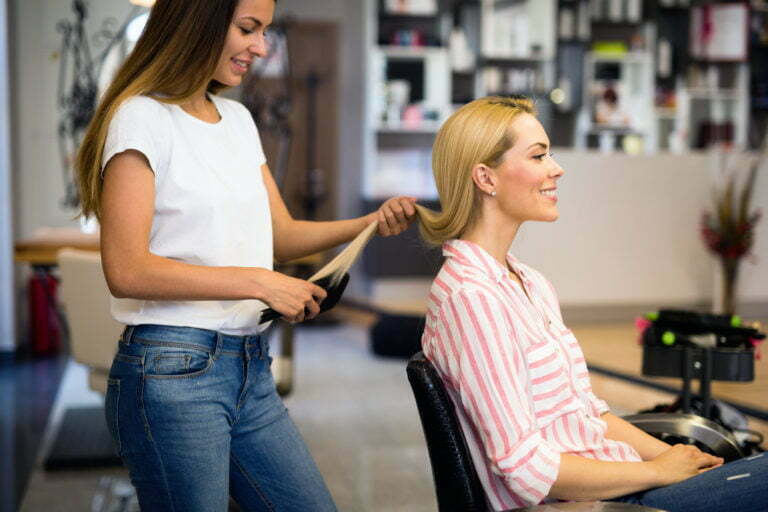 a woman holding a pen and a woman looking at her