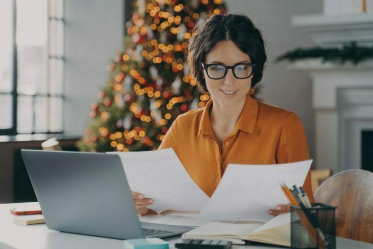 Smiling Hispanic woman employee working in office during christmas time